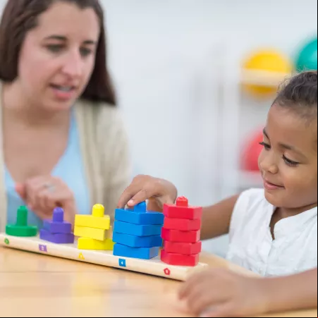 Mother and daughter playing with coloured blocks